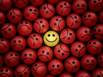 Smiley face in sea of sad faces